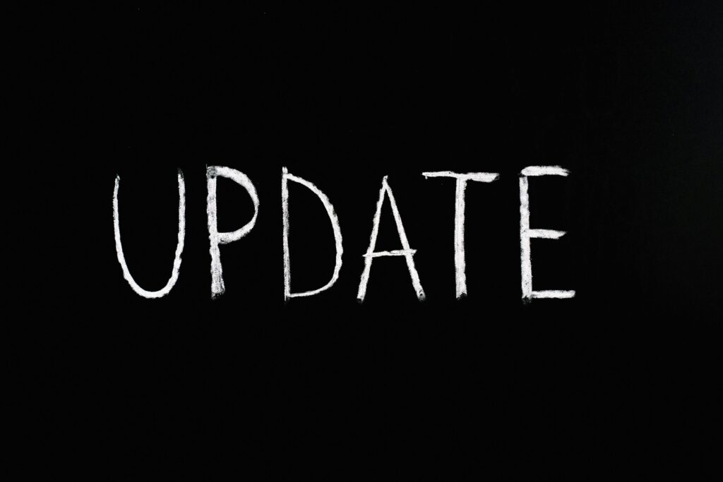 Bold 'UPDATE' text written in chalk on a blackboard. Perfect for concepts of change and communication.